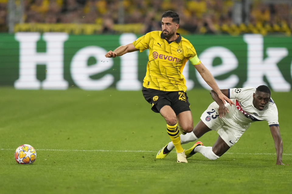 Dortmund's Emre Can is challenged by PSG's Randal Kolo Muani, right, during the Champions League semifinal first leg soccer match between Borussia Dortmund and Paris Saint-Germain at the Signal-Iduna Park stadium in Dortmund, Germany, Wednesday, May 1, 2024. (AP Photo/Matthias Schrader)