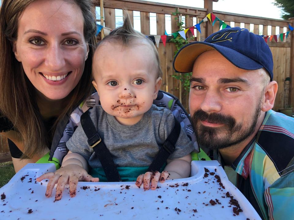 Knigge and her husband smiling beside Thorin on his first birthday (July 2018).