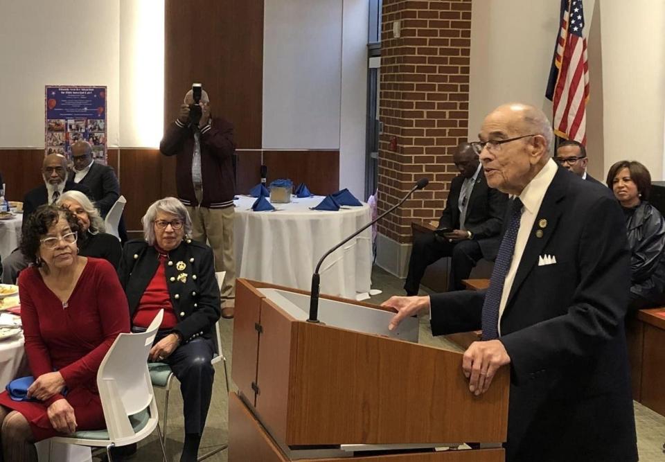 Lt. Gen. Arthur Gregg, retired, speaks to guests at Ann Taylor's 89th birthday celebration. Taylor is seated at the table on the right.