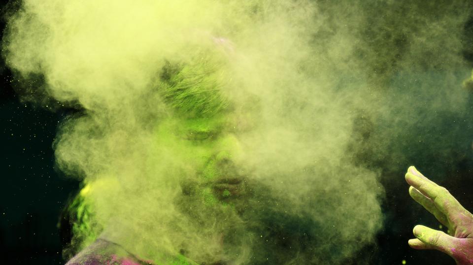 An Indian man throws colored powder on another as they celebrate Holi, the Hindu festival of colors, in Mumbai India, Monday, March 17, 2014. The festival heralds the arrival of spring. (AP Photo/ Rafiq Maqbool)