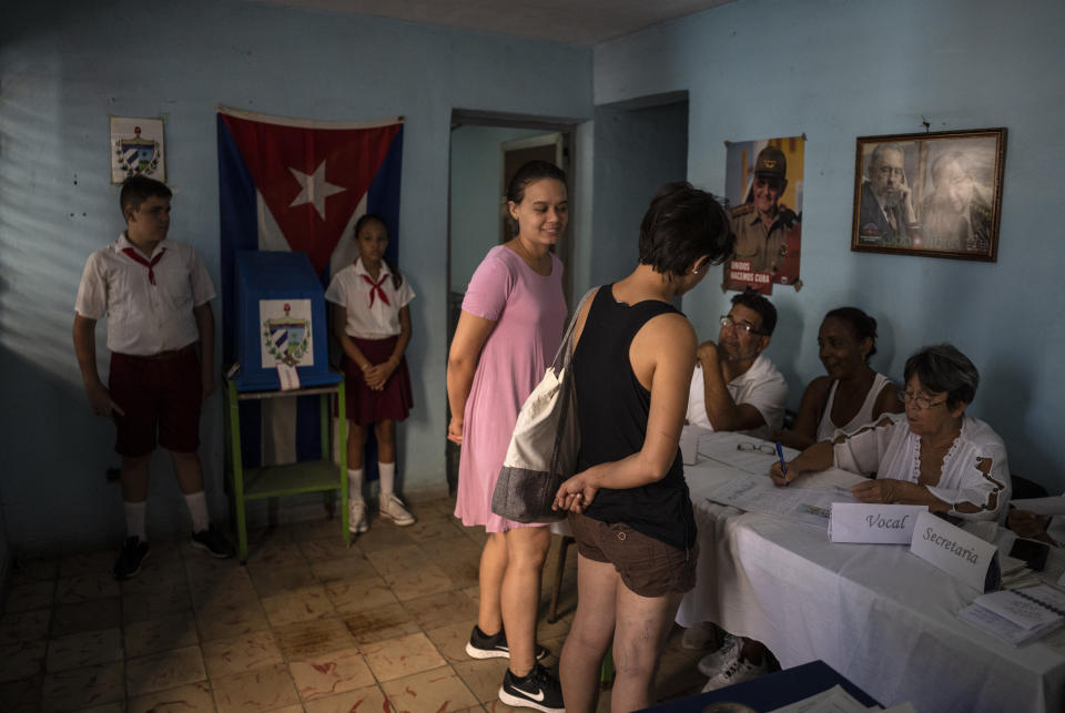Two women register to vote at a polling station during the new Family Code referendum in Havana, Cuba, Sunday, Sept. 25, 2022. (AP Photo/Ramon Espinosa)