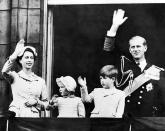 <p>Queen Elizabeth II, Prince Philip, Prince Charles, and Princess Ann salute the crowd from the balcony at Buckingham Palace following a trip around the world.</p>