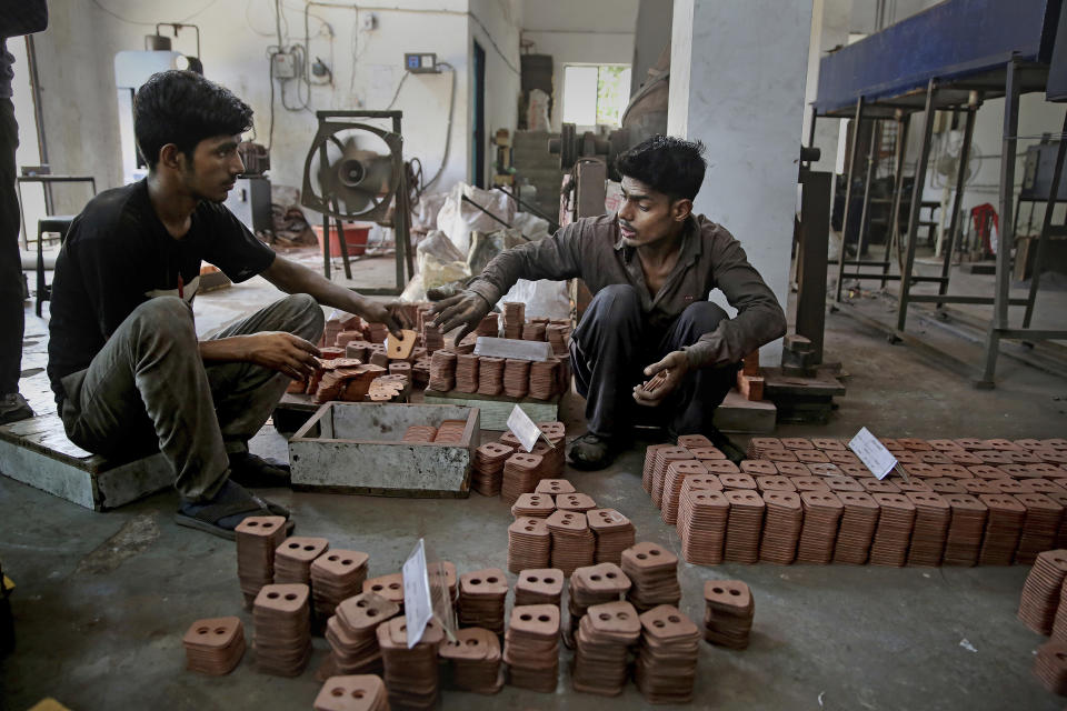 FILE - In this Sept. 5, 2019, file photo, Indian workers prepare packing of clutch buttons at an auto component manufacturing factory on the outskirts of New Delhi, India. Asian shares advanced Friday, Sept. 20, 2019, and India’s benchmark jumped 5.4% after the government announced plans to cut corporate taxes. (AP Photo/Altaf Qadri, File)
