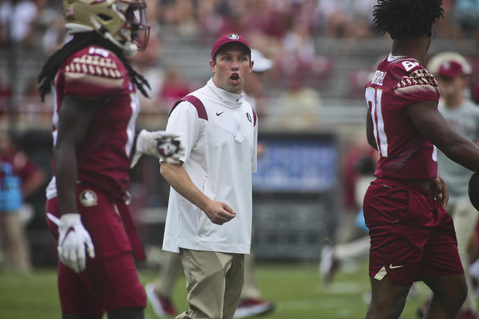 FILE - Then-Florida State offensive coordinator/quarterbacks coach Kenny Dillingham talks to players before the start of an NCAA college football game against Syracuse on Oct. 2, 2021, in Tallahassee, Fla. Arizona State hired Oregon offensive coordinator Kenny Dillingham on Sunday, Nov. 27, 2022, making the 32-year-old the youngest head football coach in a Power Five conference. (AP Photo/Phil Sears, File)