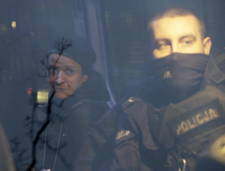 Agata Grzybowska, left, a photo journalist, is detained by police in Warsaw, Poland, on Monday Nov. 23, 2020. Police detained several people as women-led protests over abortion rights flared up again in Warsaw and elsewhere in Poland. The protests, organized by the group Women's Strike, have been occurring regularly ever since the country's constitutional court issued an Oct. 22 ruling that further tightens an abortion law that was already one of the most restrictive in Poland.(AP Photo/Czarek Sokolowski)