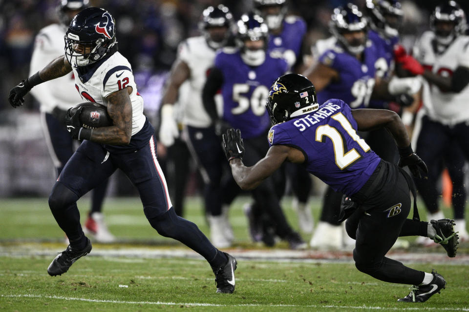 Houston Texans wide receiver Nico Collins (12) runs against Baltimore Ravens cornerback Brandon Stephens (21) during the first half of an NFL football AFC divisional playoff game, Saturday, Jan. 20, 2024, in Baltimore. (AP Photo/Nick Wass)