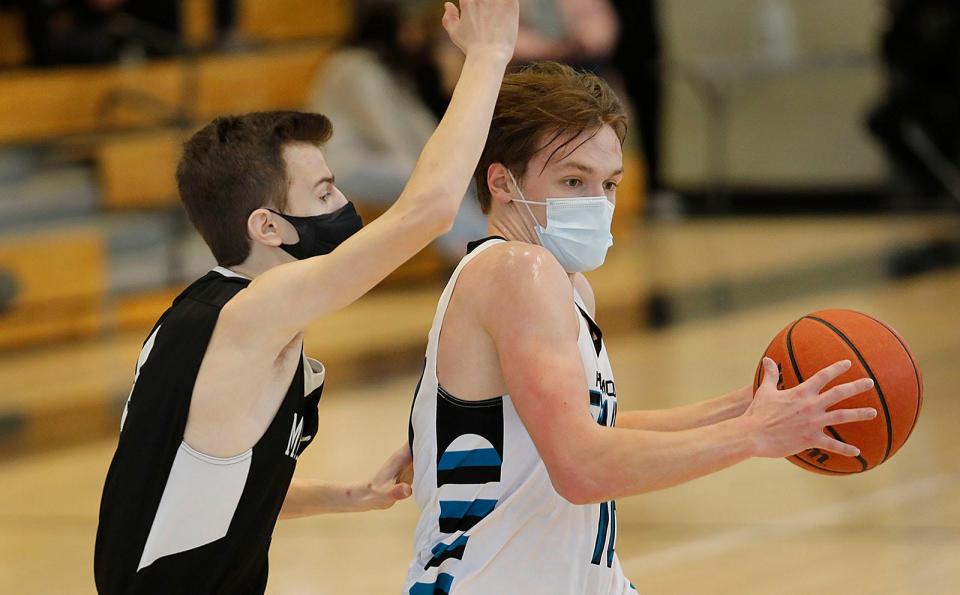 Marshfield's Rocco DeSantes puts pressure on Plymouth South's Pete Lamborn on Sunday, Feb. 14, 2021.