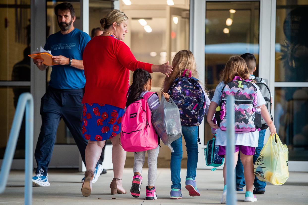 Mill Creek Elementary students arrive for the first day of school on Aug. 8, 2023, in Knoxville, Tenn.