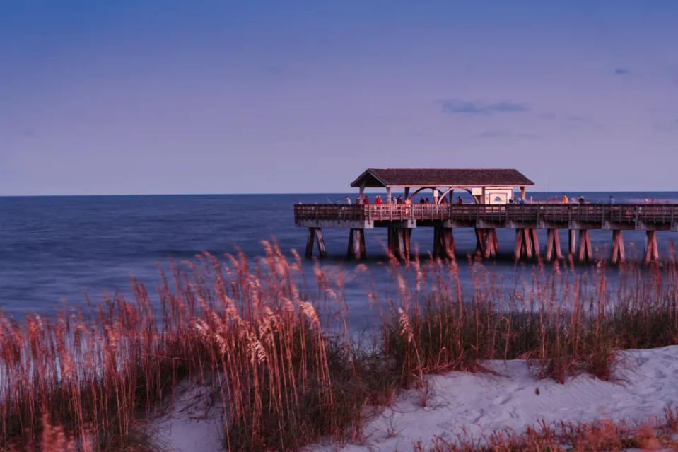 Sand dunes on Tybee island, the pier jetty via Getty Images