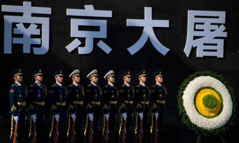 People's Liberation Army soldiers attend a memorial ceremony on China's first National Memorial Day for Nanjing Massacre Victims in Nanjing city on December 13, 2014