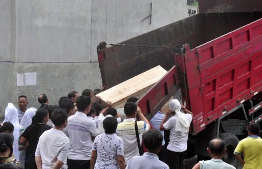 Family members carry the coffin of a miner killed in an explosion at a colliery in Lianyuan in Hunan province on Sunday. A gas blast at the mine killed seven people, state media say, the latest in a string of accidents in the country's dangerous mining industry