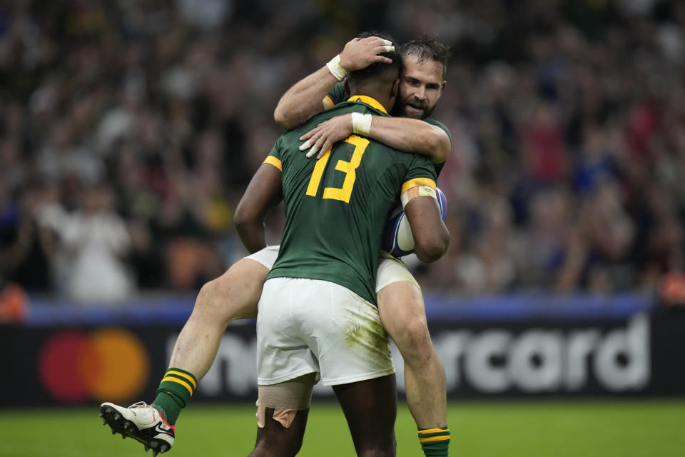 South Africa's Canan Moodie celebrates with Cobus Reinach, right, after scoring a try during the Rugby World Cup Pool B match between South Africa and Tonga, at Marseille's Stade Velodrome, France Sunday, Oct. 1, 2023. (AP Photo/Pavel Golovkin)