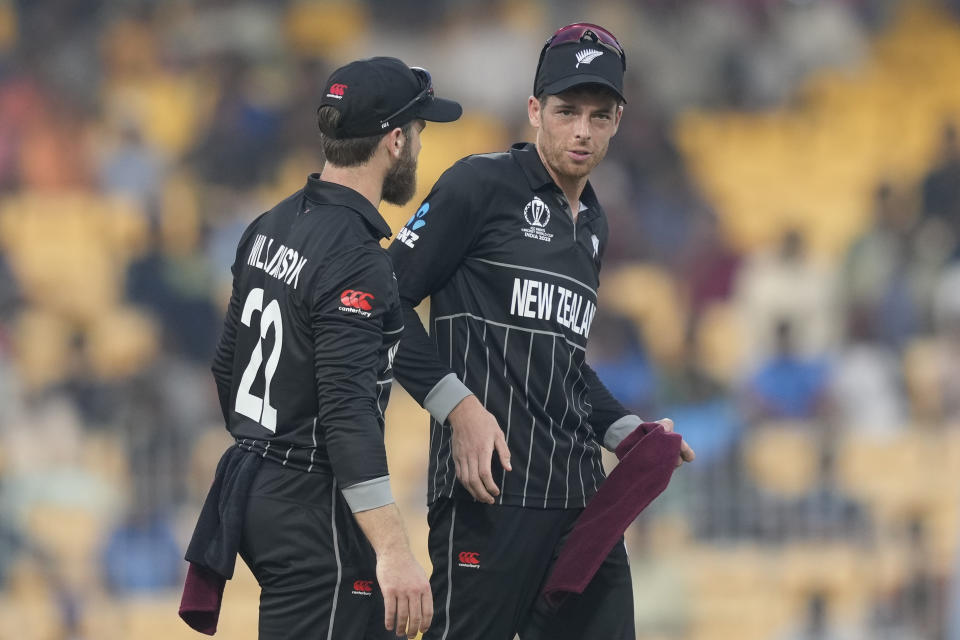 New Zealand's Mitchell Santner, right, speaks with New Zealand's captain Kane Williamson during the ICC Men's Cricket World Cup match between New Zealand and Bangladesh in Chennai , India, Friday, Oct. 13, 2023. (AP Photo/Eranga Jayawardena)