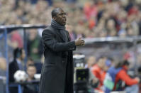 FILE - AC Milan coach Clarence Seedorf signals to his players during a Champions League, round of 16, second leg, soccer match between Atletico Madrid and AC Milan at the Vicente Calderon stadium in Madrid, Tuesday March 11, 2014. Racism has long permeated the world's most popular sport, with soccer players subjected to racist chants and taunts online. While governing bodies like FIFA and UEFA have taken steps to combat the abuse of players, the lack of diversity in the upper ranks at major clubs remains an unsolved problem. Seedorf was hired by Italian giant AC Milan in 2014 but lasted only four months. (AP Photo/Paul White, File)