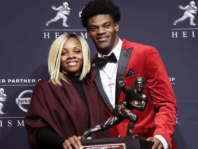 <p>John Angelillo/UPI/Alamy</p> Lamar Jackson stands with mom Felicia Jones after winning the Heisman award in 2016.