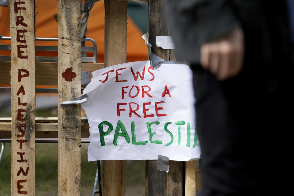 A sign is seen on the fence in a pro-Palestinian encampment at Main Quadrangle on the University of Chicago campus, Monday, May 6, 2024, in Chicago. (AP Photo/Nam Y. Huh)