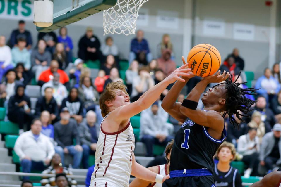 Edmond Memorial's Ciaran Pedulla defends as Choctaw's Ja'Mon Valentine goes up for a shot during the Bishop McGuinness Classic on Saturday.