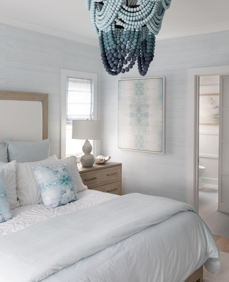 <p> &#x2018;Blue&#x2019; can cover a multitude of shades, from almost blue-black to a barely-there pastel shade. They all have their place and the color you choose will depend on how big your bedroom is, what depth of color you want, and how you apply it.&#xA0; </p> <p> This calming blue bedroom by Karen B Wolf Interiors shows you the other end of the scale &#x2013; subtle shades of sky blue teamed with pale blonde wood and textured white bedding. The only punchy factor is the beaded chandelier that shows three darker shades. </p>