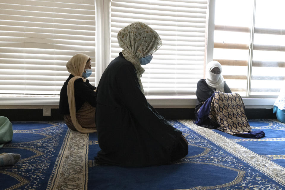 Shukri Olow, center, a Muslim woman who is running for King County Council District 5, prays at the Islamic Center of Kent, Friday, Aug. 13, 2021, in Kent, Wash., south of Seattle. Muslim Americans in their 20s and 30s who grew up amid the aftershocks of the Sept. 11, 2001 terrorist attacks came of age in a world not necessarily attuned to their interests, their happiness and their well-being. Olow says the aftermath of the attacks has helped motivate her to become a community organizer and to run for office in Washington state. (AP Photo/Karen Ducey)