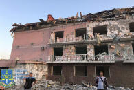 ADDS: FACES WERE BLURRED BY THE SOURCE - In this photo provided by the Odesa Regional Prosecutor's Office and whose faces were blurred by the source, a damaged residential building is seen in Odesa, Ukraine, early Friday, July 1, 2022, following Russian missile attacks. Ukrainian authorities said Russian missile attacks on residential buildings in the port city of Odesa have killed more than a dozen people. (Odesa Regional Prosecutor's Office via AP)