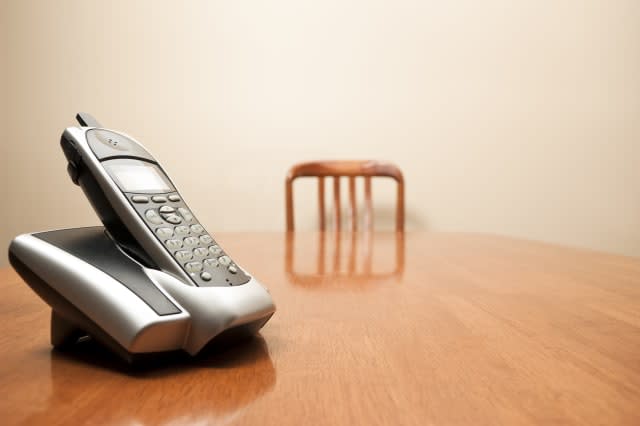 a modern cordless phone sits on ...