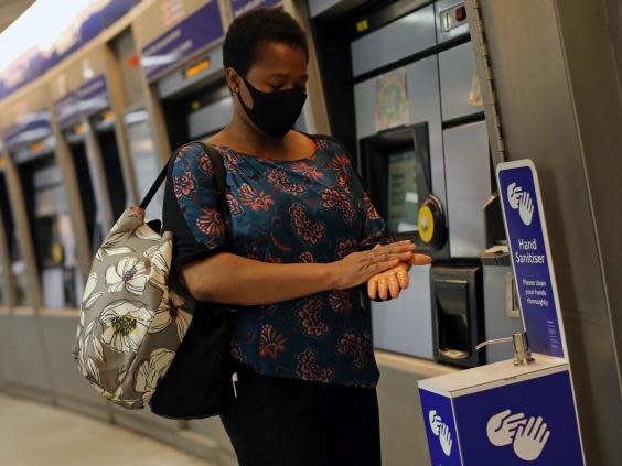 Everyone should continue to wash their hands frequently and not touch their face at all times, whether or not you are wearing a face covering (AFP via Getty Images)