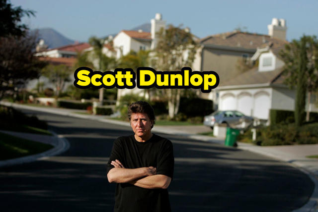 Scott Dunlop standing in a suburban street with his arms folded