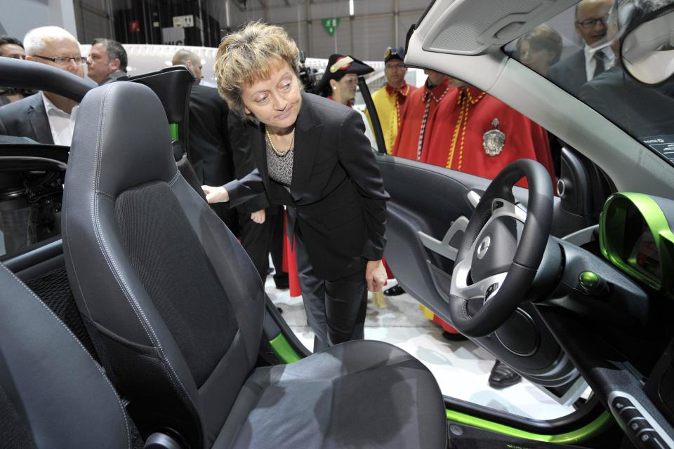 Swiss Federal President Eveline Widmer-Schlumpf, looks at the Smart electric drive generation III car during the opening day of the 82st Geneva International Motor Show in Geneva, Switzerland, Thursday, March 8, 2012. The Motor Show  opens its gates to the public from 8th to 18th of  March presenting more than 260 exhibitors and more than 180 world and European premieres. (AP Photo/Keystone/Martial Trezzini)