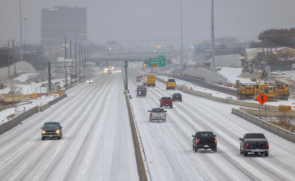 Cars move along icy roads on U.S. 75 near Skillman Street in Dallas on Tuesday, Jan. 31, 2023. The cold weather and icy conditions coating North Texas are likely to continue through Thursday morning as the National Weather Service extends its winter weather storm warning. (Liesbeth Powers/The Dallas Morning News via AP)