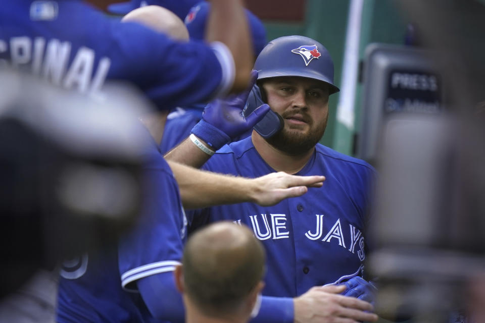 Toronto Blue Jays' Rowdy Tellez is welcomed to the dugout after hitting a home run in the sixth inning of a baseball game against the Boston Red Sox, Sunday, Sept. 6, 2020, in Boston. (AP Photo/Steven Senne)