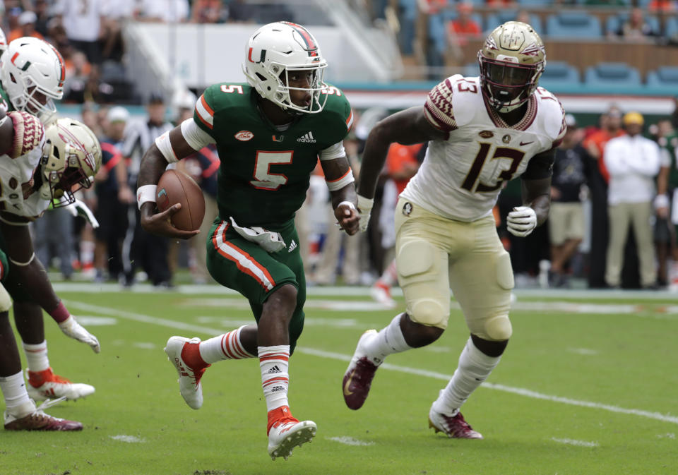 Miami quarterback N'Kosi Perry (5) runs as Florida State defensive end Joshua Kaindoh (13) defends during the first half of an NCAA college football game, Saturday, Oct. 6, 2018, in Miami Gardens, Fla. (AP Photo/Lynne Sladky)