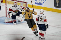 Vegas Golden Knights right wing Mark Stone celebrates a goal by teammate Jonathan Marchessault during the first period of Game 2 of the NHL hockey Stanley Cup Finals against the Florida Panthers, Monday, June 5, 2023, in Las Vegas. (AP Photo/Abbie Parr)