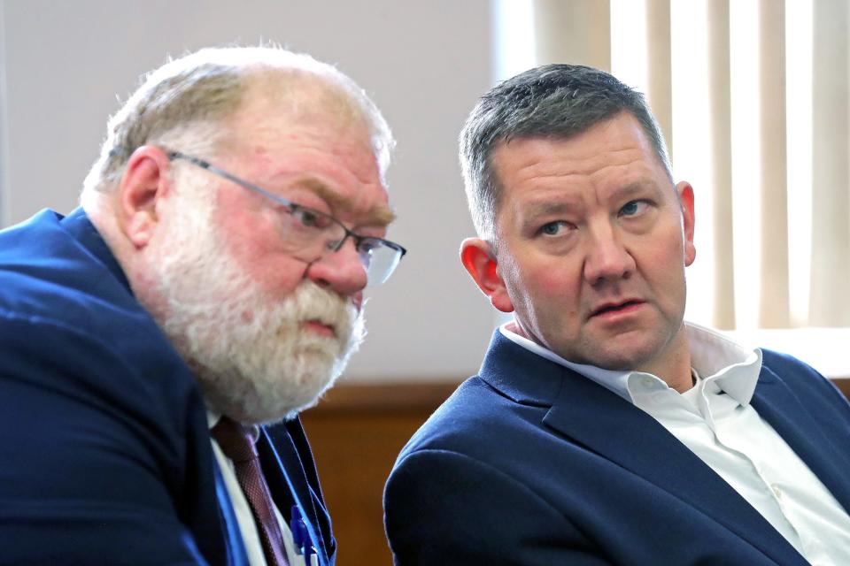Former state Rep. Bob Young, right, has a word with his attorney Mike Callahan before accepting a plea agreement that resolved his remaining cases and allowed him to avoid any jail time during a hearing at Barberton Municipal Court Thursday.