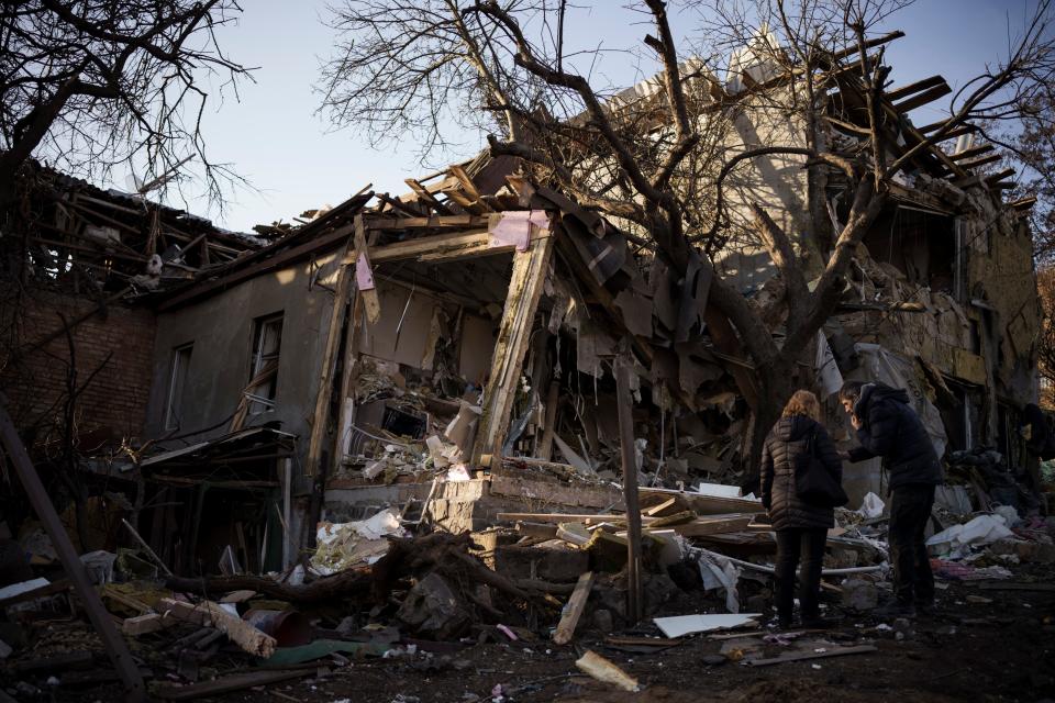 January 2, 2023:  Serhii Kaharlytskyi, right, stands outside his home, destroyed after a Russian attack in Kyiv, Ukraine. Kaharlytskyi's wife Iryna died in the attack on Dec. 31, 2022.