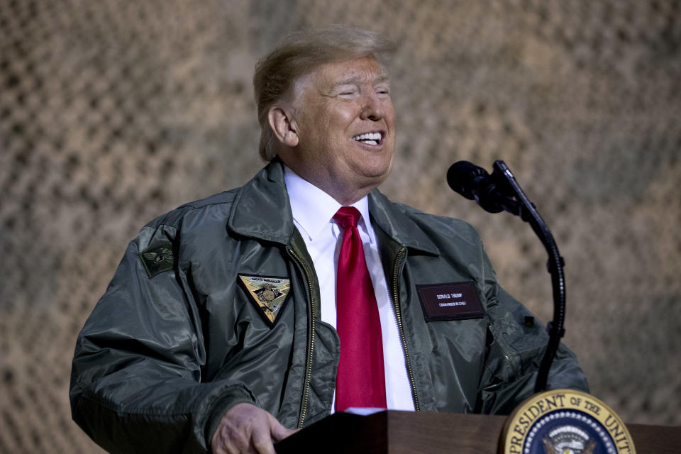 President Donald Trump speaks at a hangar rally at Al Asad Air Base, Iraq, Wednesday, Dec. 26, 2018. President Donald Trump, who is visiting Iraq, says he has 'no plans at all' to remove US troops from the country. (AP Photo/Andrew Harnik)