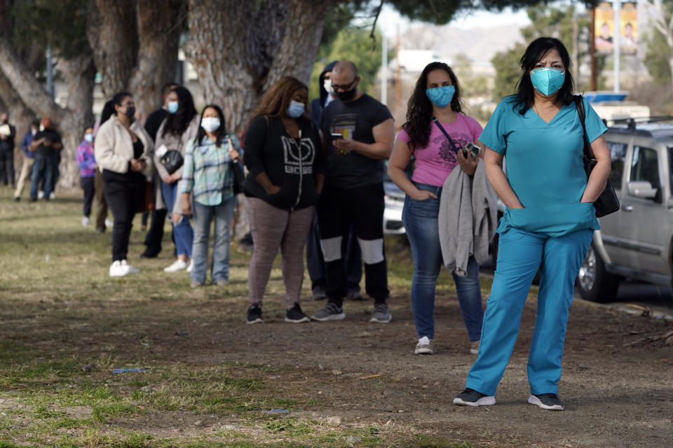 Health care workers line up to receive at a COVID-19 vaccination at Ritchie Valens Recreation Center, Wednesday, Jan. 13, 2021, in Pacoima, Calif. (AP Photo/Marcio Jose Sanchez)