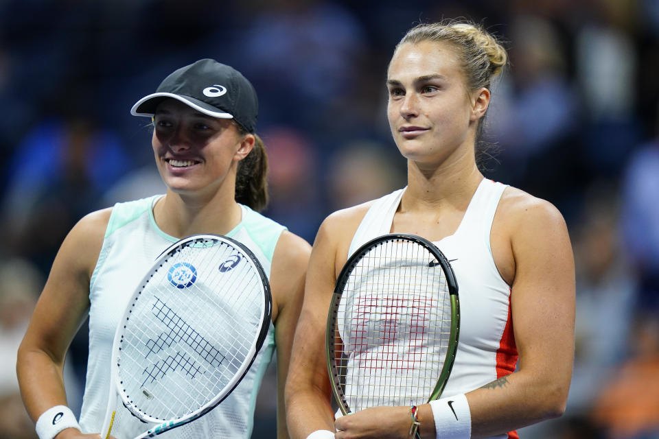 Iga Swiatek, of Poland, left, poses for a photo with Aryna Sabalenka, of Belarus, during the semifinals of the U.S. Open tennis championships, Thursday, Sept. 8, 2022, in New York. (AP Photo/Frank Franklin II)