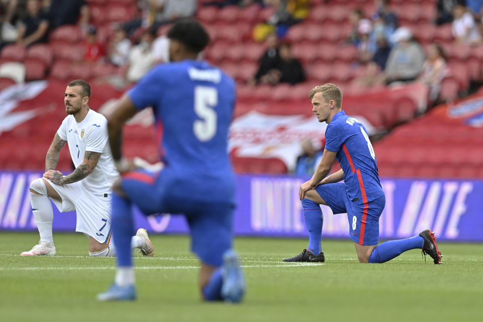 Image: England's and Romania's players take a knee before the international friendly soccer match between England and Romania in Middlesbrough, England (Paul Ellis / AP)