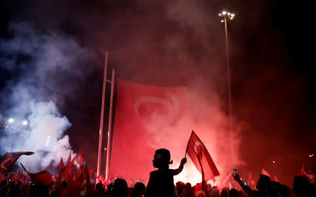 A young boy waves a Turkish national flag as supporters of Turkish President Tayyip Erdogan gather during a pro-government demonstration on Taksim square in Istanbul, Turkey, July 18, 2016. REUTERS/Alkis Konstantinidis