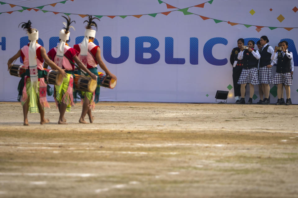 Assam police woman band members take photographs of Tiwa tribals participating in a Republic Day parade in Guwahati, India, Thursday, Jan. 26, 2023. (AP Photo/Anupam Nath)