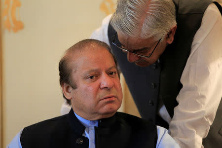 Former Pakistani Prime Minister Nawaz Sharif speaks with an official during a meeting in Islamabad, Pakistan August 9, 2017. REUTERS/Caren Firouz