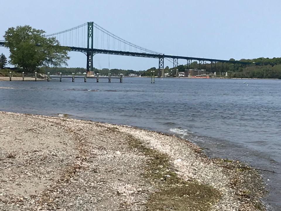 The Mount Hope Bridge is visible from a beach in the Bertha Russell Preserve at Portsmouth's Town Pond Trail.