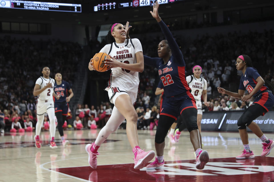 South Carolina center Kamilla Cardoso, center left, drives to the basket past Mississippi forward Tyia Singleton (22) during the second half of an NCAA college basketball game Sunday, Feb. 4, 2024, in Columbia, S.C. (AP Photo/Artie Walker Jr.)