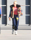 <p>Gwen Stefani totes her furry friend along as she heads to a private jet in L.A. on Dec. 26. </p>