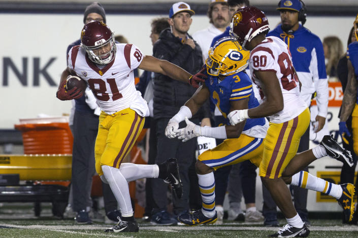 Southern California wide receiver Kyle Ford (81) stiff-arms California safety Elijah Hicks (3) as he runs a pass reception in a for a touchdown during the second quarter of an NCAA college football game Saturday, Dec. 4, 2021, in Berkeley, Calif. (AP Photo/D. Ross Cameron)