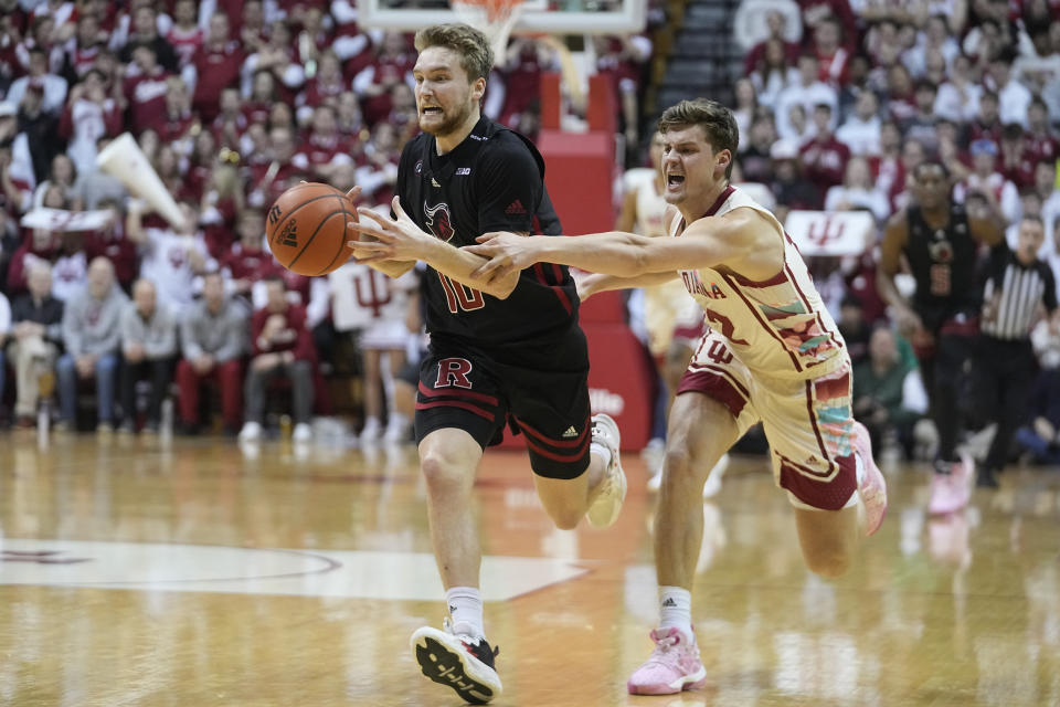 Rutgers guard Cam Spencer (10) has the ball knocked out of his hands by Indiana forward Miller Kopp (12) during the first half of an NCAA college basketball game Tuesday, Feb. 7, 2023, in Bloomington, Ind. (AP Photo/Darron Cummings)
