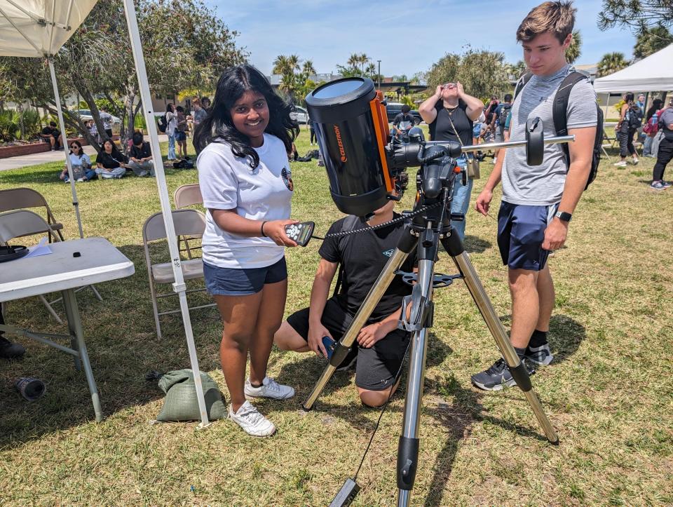 Gayathri Vinil, 19, poses with a telescope at Florida Tech. She came from Kenya to study astrophysics.