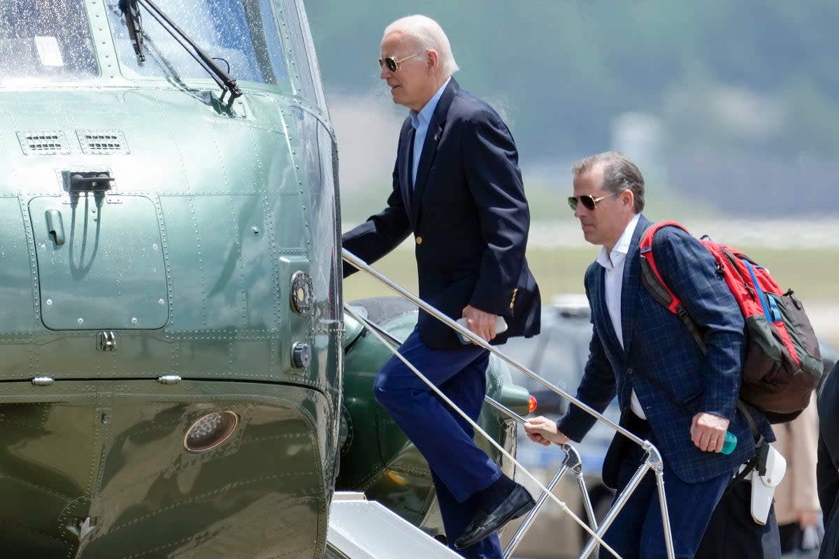 Joe Biden and his son Hunter boarding Marine One at Andrews Air Force Base in June. Gal Luft has made allegations of corruption against them  (AP)