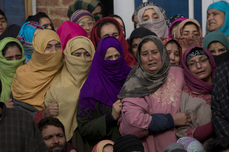 Kashmiri women react as they watch the funeral procession of Umar Ramzan, a local rebel in Tral, south of Srinagar, Indian controlled Kashmir, Saturday, Dec. 22, 2018. A gunbattle between Indian troops and Kashmiri rebels early Saturday left six militants dead and triggered a new round of anti-India protests in the disputed Himalayan region. (AP Photo/Dar Yasin)