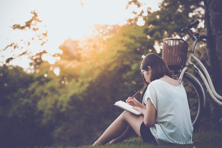 <span class="caption">Keeping a journal outdoors could be motivating.</span> <span class="attribution"><a class="link " href="https://www.shutterstock.com/image-photo/beautiful-woman-writing-into-her-diary-658438873" rel="nofollow noopener" target="_blank" data-ylk="slk:Teechai/Shutterstock;elm:context_link;itc:0;sec:content-canvas">Teechai/Shutterstock</a></span>